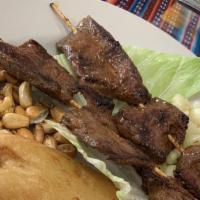 Anticuchos · Barbecued chunks of beef heart cooked in vegetable charcoal marinates in spicy vinegar serve...