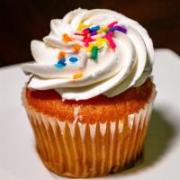 Vanilla · Vanilla cake filled with vanilla pudding topped with vanilla buttercream + rainbow sprinkles.