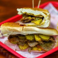 Greek-Cubano · Lamb & Beef Gyro Meat  with ham, Swiss cheese, pickles, and mustard  
pressed together on  a...