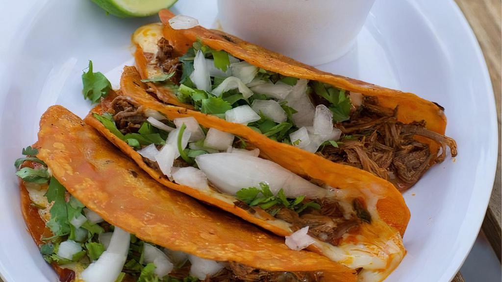 Red Tacos (Birria) · Beef Birria  (mexican meat stew),  onion, cilantro & consome (soup)