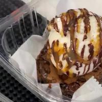 Brownie Overload · Chocolate brownie topped with a scoop of ice cream, chocolate syrup, caramel, and a side of ...