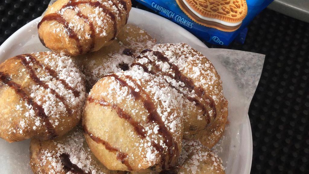 Fried Oreos  · Golden-fried Oreos dusted with powdered sugar.