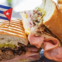 Cubano · Home cooked roasted pork, Ham, swiss cheese, mustard, pickles.