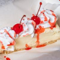 Cheesecake · Light and fluffy cheesecake, topped with whipped cream, cherry, and drizzle of chocolate, st...