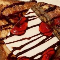 Peanut Butter & Banana Stuffed French Toast · Challah bread stuffed with peanut butter and fresh bananas, topped with raspberry coulis, po...