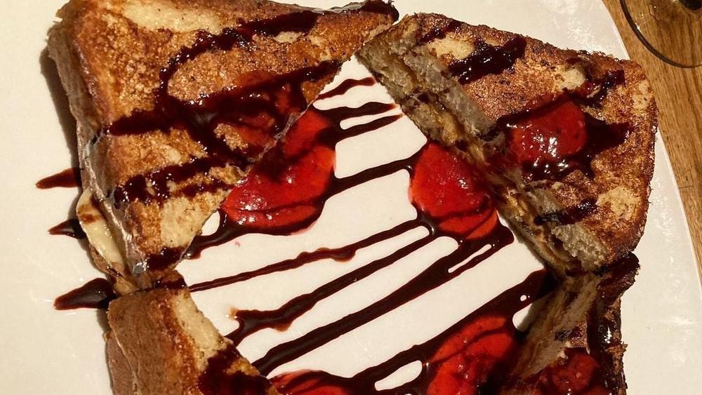 Peanut Butter & Banana Stuffed French Toast · Challah bread stuffed with peanut butter and fresh bananas, topped with raspberry coulis, powdered sugar and chocolate sauce.