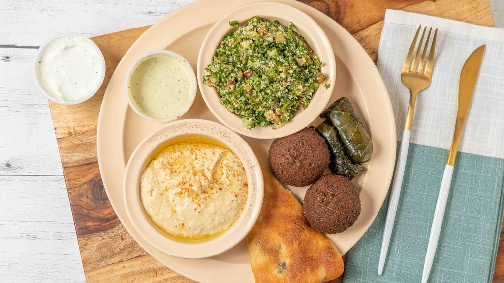 Veggie Platter (For One) · Two falafels, one spinach pies, two veggie grape leaves, two sides.