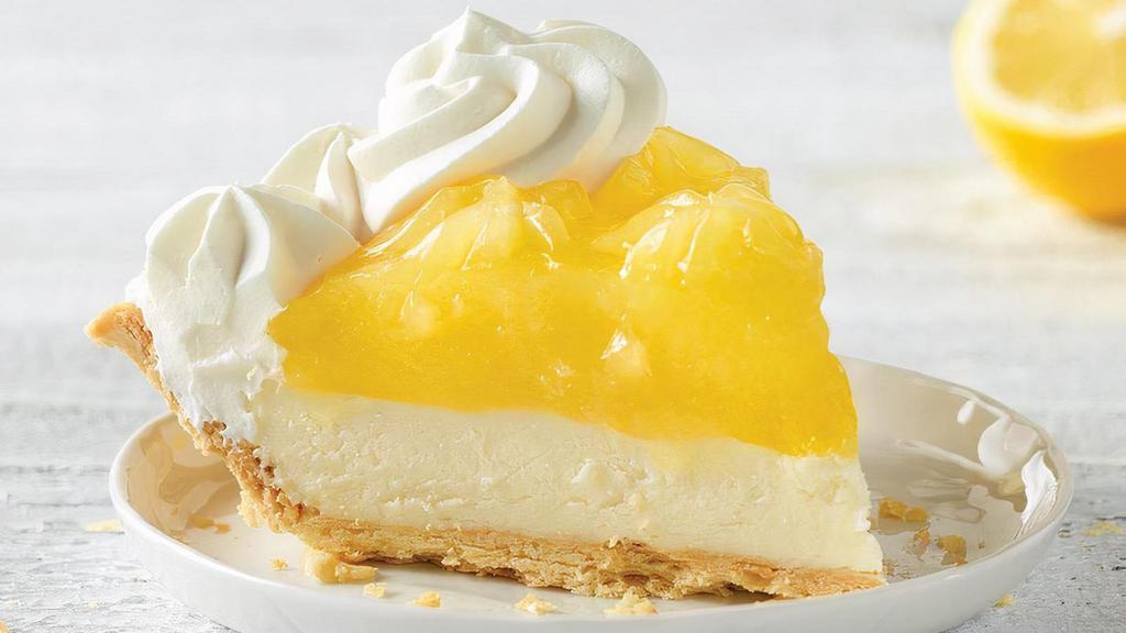 Lemon Supreme Pie Slice · Tangy lemon filling over cool, creamy supreme filling inside our flaky, golden pie crust, then topped with real whipped cream.