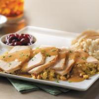 Slow-Roasted Turkey · Hand-carved and served with cornbread stuffing, mashed potatoes and turkey gravy, and cranbe...