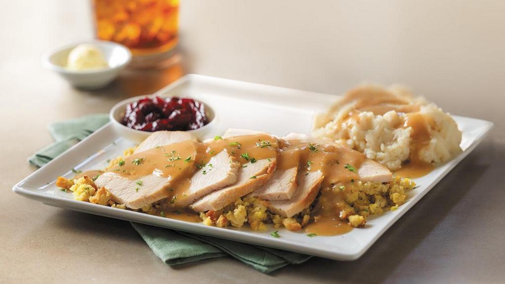 Slow-Roasted Turkey · Hand-carved and served with cornbread stuffing, mashed potatoes and turkey gravy, and cranberry sauce. (Serves 4 - 6)