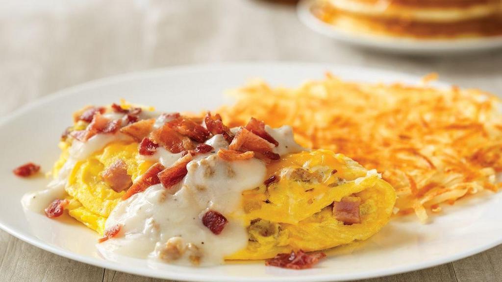 Country Music Star Omelette* · House-made sausage, diced ham and onions, topped with Cheddar and Monterey Jack cheeses, country sausage gravy and bacon.