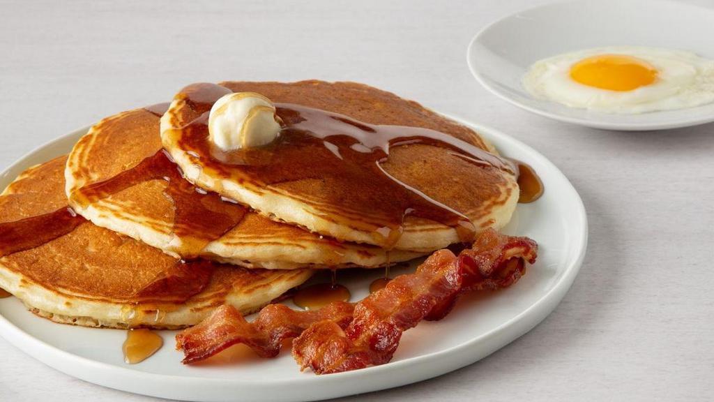 Buttermilk Pancake Combo* · One egg, any style, three buttermilk pancakes with two cherrywood-smoked bacon strips, two sausage links or one house-made sausage patty.