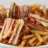 Double Decker Club · Hand-carved turkey breast, ham, bacon and American cheese, with tomato, lettuce and mayo on ...