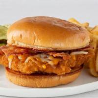 Chicken Ranch · Chicken-fried chicken breast, Cheddar and Monterey Jack cheeses and two bacon strips on a gr...