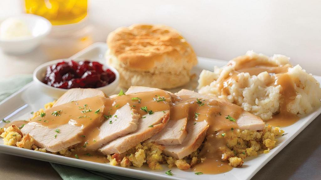 Slow-Roasted Turkey · Hand-carved and served with cornbread stuffing, mashed potatoes and turkey gravy, cranberry sauce and a buttermilk biscuit.