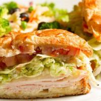 Turkey Parsant · Smoked turkey and provolone on a croissant with lettuce, tomato, and mayo.  Served with past...