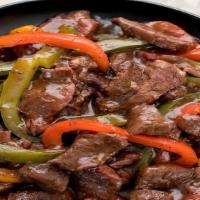 Pepper Steak · Sautéed flank steak, black pepper, onions, bell peppers, tomatoes, and mixed vegetables.