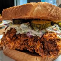 Nashville Hot Chicken Sandwich · Chicken breast covered in nashville hot sauce, lettuce, tomato, pickles, house sauce and may...