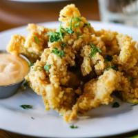 Fried Cracked Conch · Tenderized, breaded, and deep-fried conch, served with our homemade tartar sauce.