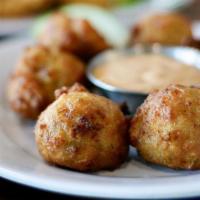 Conch Fritters · Tender pieces of conch, finely chopped with onions & peppers, mixed with spices and batter, ...