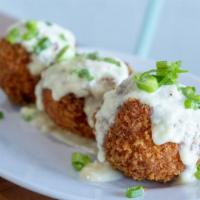 Lobster Mac & Cheese Croquettes · Lightly breaded, and deep fried to perfection topped with a parmesan cheese sauce