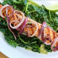 Salmon Over Spinach · Grilled salmon served over a bed of sautéed spinach.