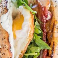 Breakfast Bagel · Over easy egg, crispy bacon, arugula, cream cheese and peach jam.