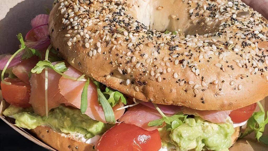 Smoked Salmon Bagel · Cream cheese, smoked wild salmon, smash avocado, red onions, baby capers, cherry tomato and microgreens. Note: Choose your eggs.