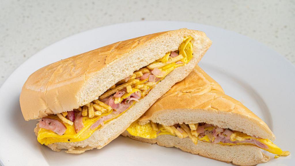 Pan Con Tortilla · Egg Omelet with ham & cheese, marinated onions and potato sticks on toasted Cuban bread