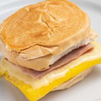 Breakfast Sandwich · Scrambled eggs with white American cheese and Bacon OR Ham on a toasted Cuban Roll