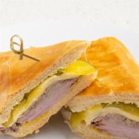 Cuban Sandwich / Cubano · Roasted Pork, Ham, Swiss Cheese, Pickles & Mustard on toasted Cuban Bread