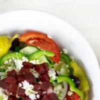 Greek Salad · For a little extra, get it chopped. Crispy lettuce, tomatoes, cucumbers, onions, olives, bee...