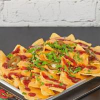 Beef & Queso Loaded Nachos  · Crispy corn tortilla chips with spiced ground beef, shredded cheese, queso, pickled jalapeno...
