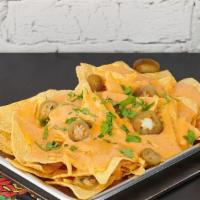 Small Nachos · Crispy corn tortilla chips with shredded cheese, queso, pickled jalapeno, cilantro, and your...