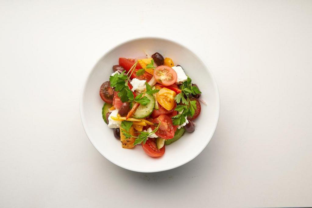 Greek Tomato Salad · Heirloom tomatoes, peppers, cucumber, red & white onions, feta, Greek olives.