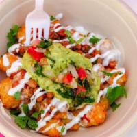 Loaded Tots · Crispy tots topped with queso, charro beans, pico, taco shop guac, and crema.
