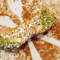 Cannoli · Fresh cream filled shell with pistachio dust.