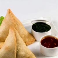 Samosa Chicken · Triangular pastry shells stuffed with a savory filling of spiced minced chicken, deep-fried,...