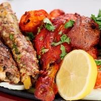 Tandoori Mix Grill Platter · Seekh kabab (beef and chicken,) chicken tikka, Bihari beef kabab, and leg of tandoori chicke...