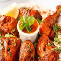 Whole Tandoori Chicken · Marinated whole chicken with yogurt and herbs baked in a clay oven tandoor. Served with naan...