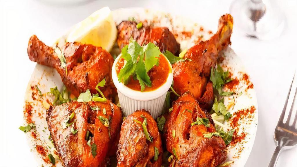 Whole Tandoori Chicken · Marinated whole chicken with yogurt and herbs baked in a clay oven tandoor. Served with naan or rice.