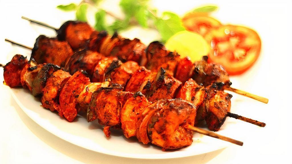 Chicken Tikka · Boneless tender chicken breast, marinated overnight with yogurt and herbs, charbroiled to perfection. Served with naan or rice.
