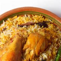 Chicken Biryani · Long grain basmati rice cooked with chicken to perfection over a low flame. Garnished with c...