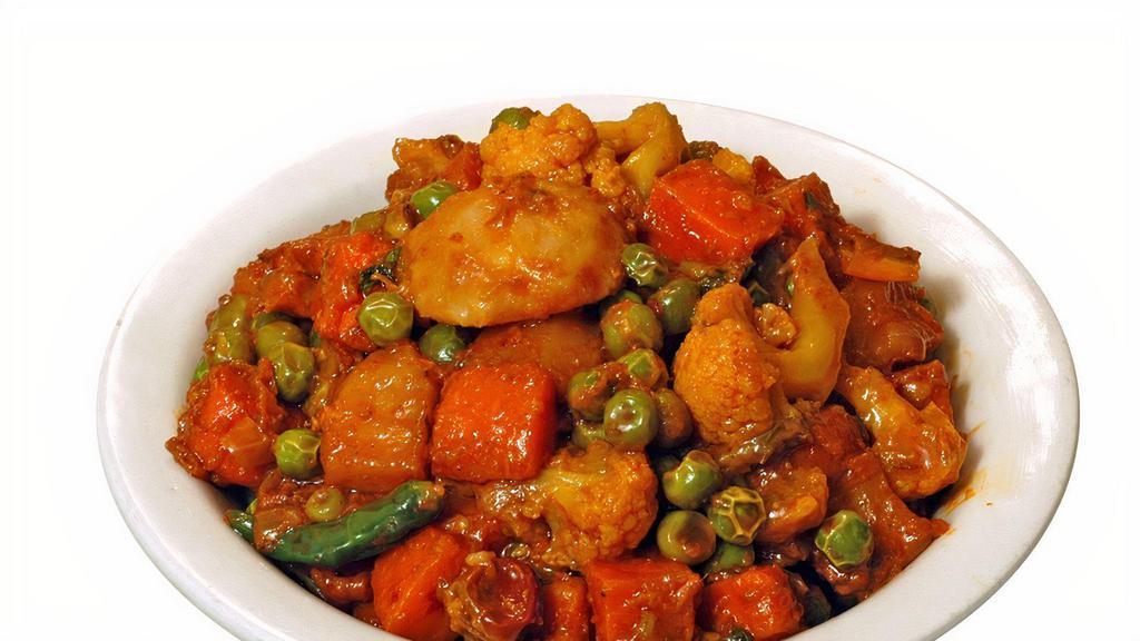 Mix Veg · Medley of vegetables cooked in onion, tomatoes, and bell peppers with curry sauce.