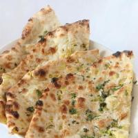Onion Kulcha · Oven fresh baked bread stuffed with caramelized spiced onions.