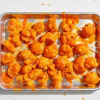 Medium Cauliflower Bites · Florets of cauliflower battered and fried, covered with your choice of sauce. Served with ce...