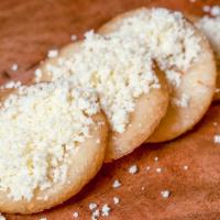 Arepitas Con Queso · 4 fried small arepas with cheese on top.