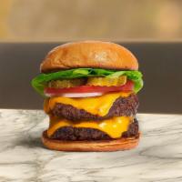 Double Empire Burger · Two 1/2 lb. beef patties topped with melted cheese, lettuce, tomato, and onion. Served on a ...