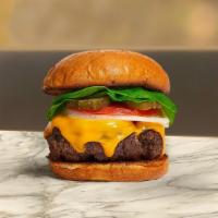 Cheese Feast Burger · 1/2 lb. beef patty topped with melted cheese, lettuce, tomato, and onion. Served on a warm b...