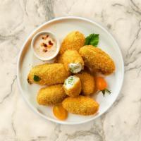 Jalapeño Poppers · Vegetarian. Fresh jalapeños coated in cream cheese and fried until golden brown.